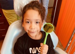 little girl showcasing dental health crafts for preschoolers