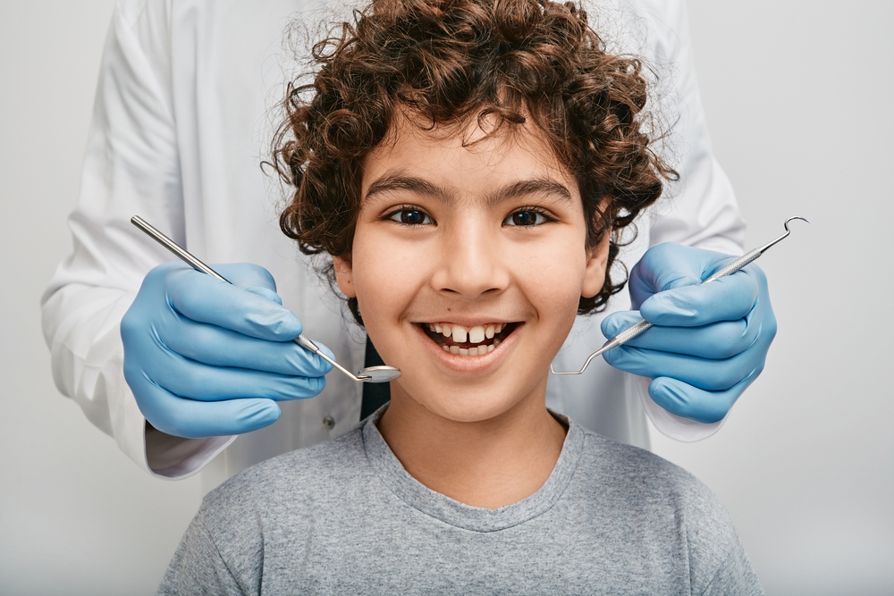 child’s tooth is loose but won’t come out.