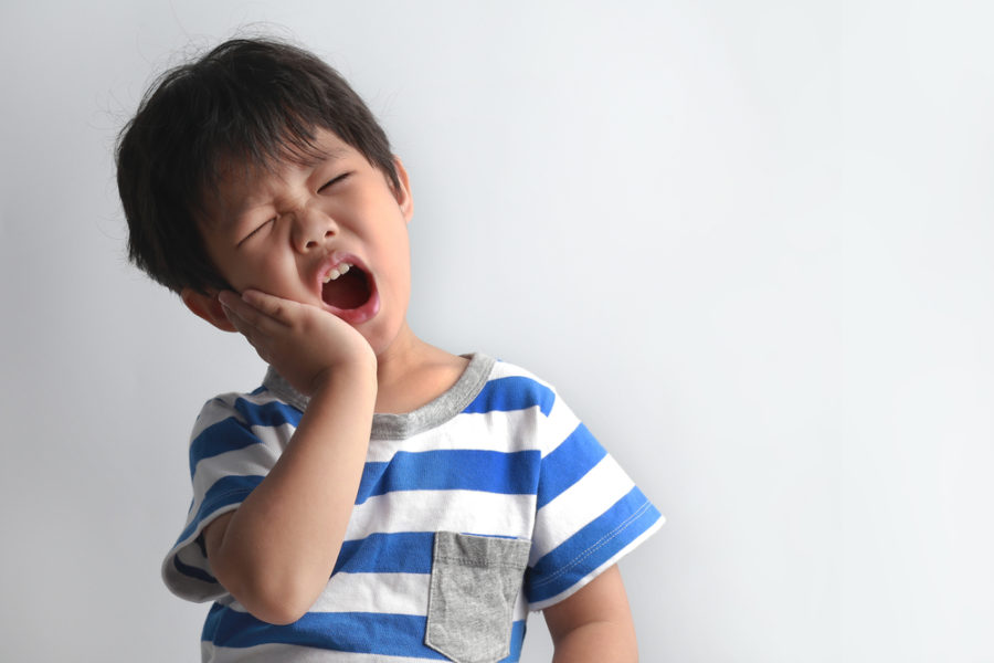 Kid having pain in teeth due to cavity